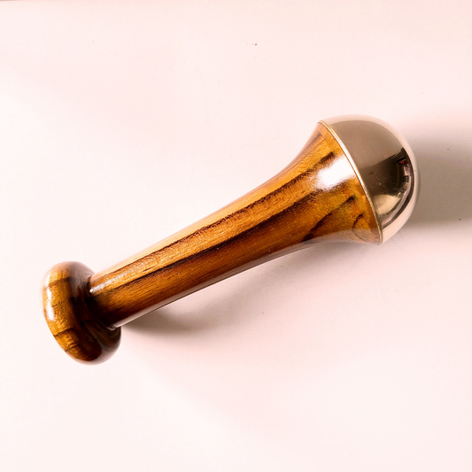 kansa wand, an ayurvedic face massager to increase lymphatic drainage, reduce wrinkles and tighten and brighten skin