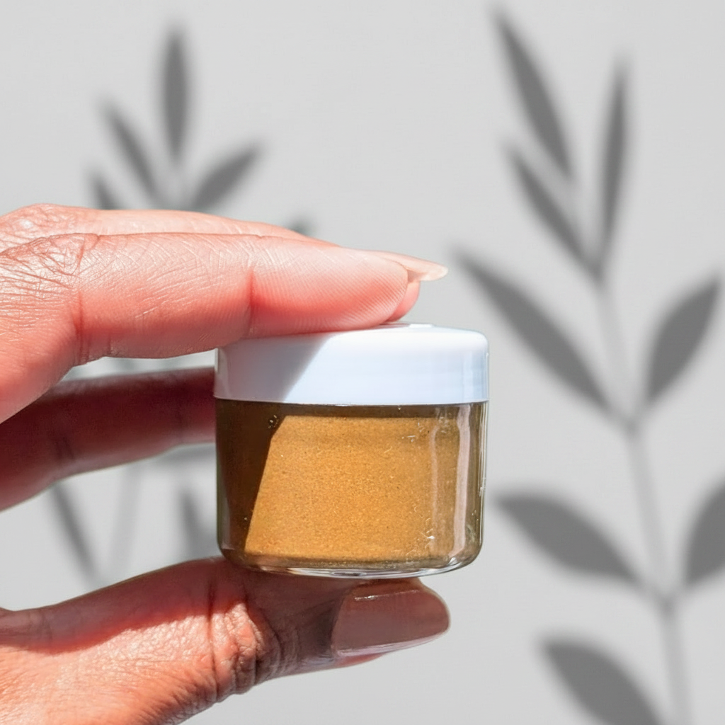 A jar of Triphala Purifying Face Mask by Herbal Edge, set against a backdrop with stones, likely indicating a natural or Ayurvedic product.