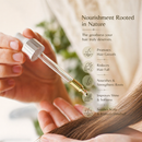 Hand holding a dropper with hair oil and text about hair care benefits like promotes hair growth, reduces hair fall, improves shine