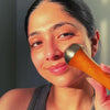 girl using the kansa wand face ayurvedic massager and showing how to use it